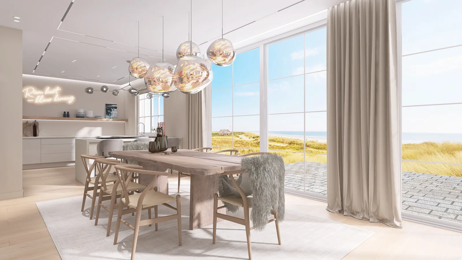 Ferienhaus Sylt, Essplatz mit Glasleuchten, dahinter Küche mit Schriftzug